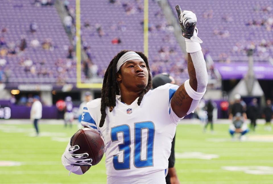 Lions running back Jamaal Williams throws a ball to a fan during pregame against the Vikings on Sunday, Oct. 10, 2021, in Minneapolis.