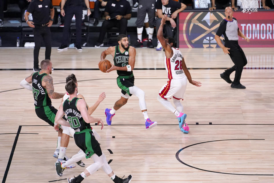 Boston Celtics' Jayson Tatum (0) drives against Miami Heat's Andre Iguodala (28) during the second half of an NBA conference final playoff basketball game Friday, Sept. 25, 2020, in Lake Buena Vista, Fla. The Celtics won 121-108. (AP Photo/Mark J. Terrill)