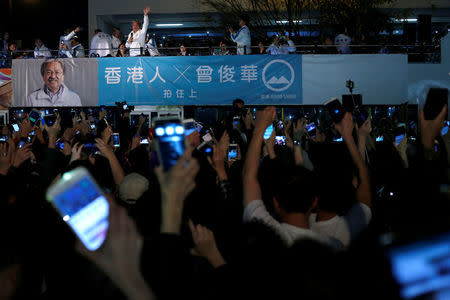 Chief Executive candidate and former Financial Secretary John Tsang waves to supporters during a campaign rally in Hong Kong, China March 24, 2017. REUTERS/Tyrone Siu