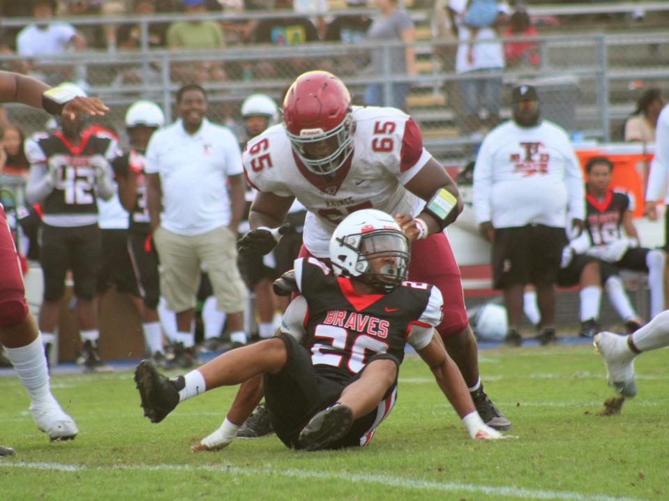 Offensive lineman Solomon Thomas blocks a defender during Raines' spring game against Terry Parker.