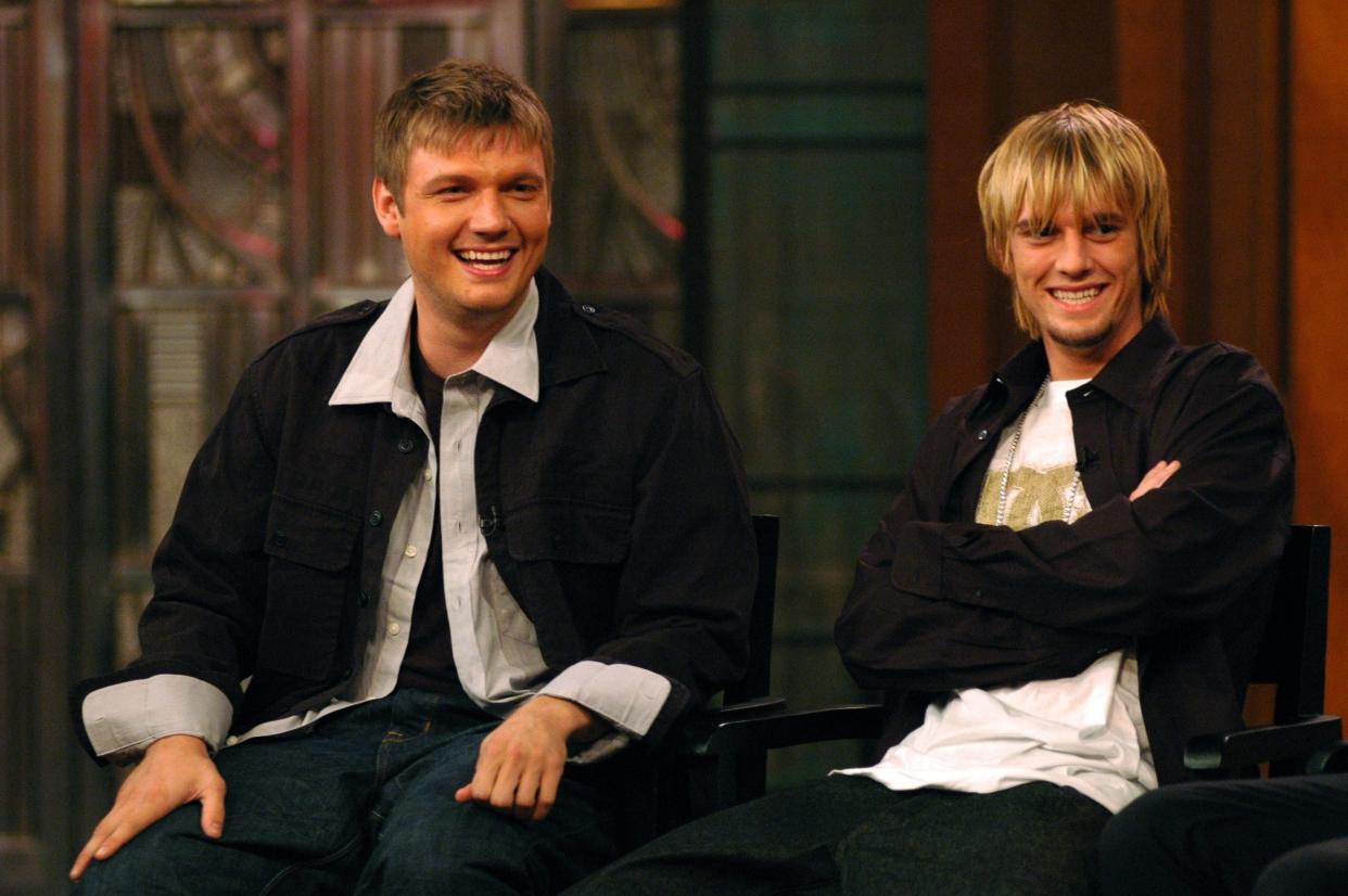 Nick Carter and Aaron Carter in black jackets and white shirts