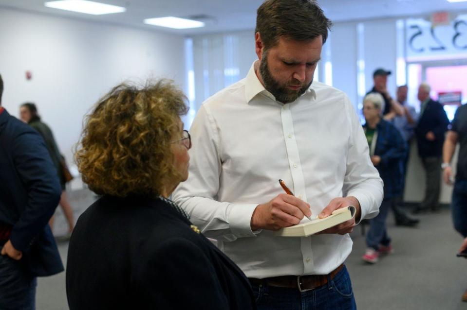 Vance signs a copy of "Hillbilly Elegy."