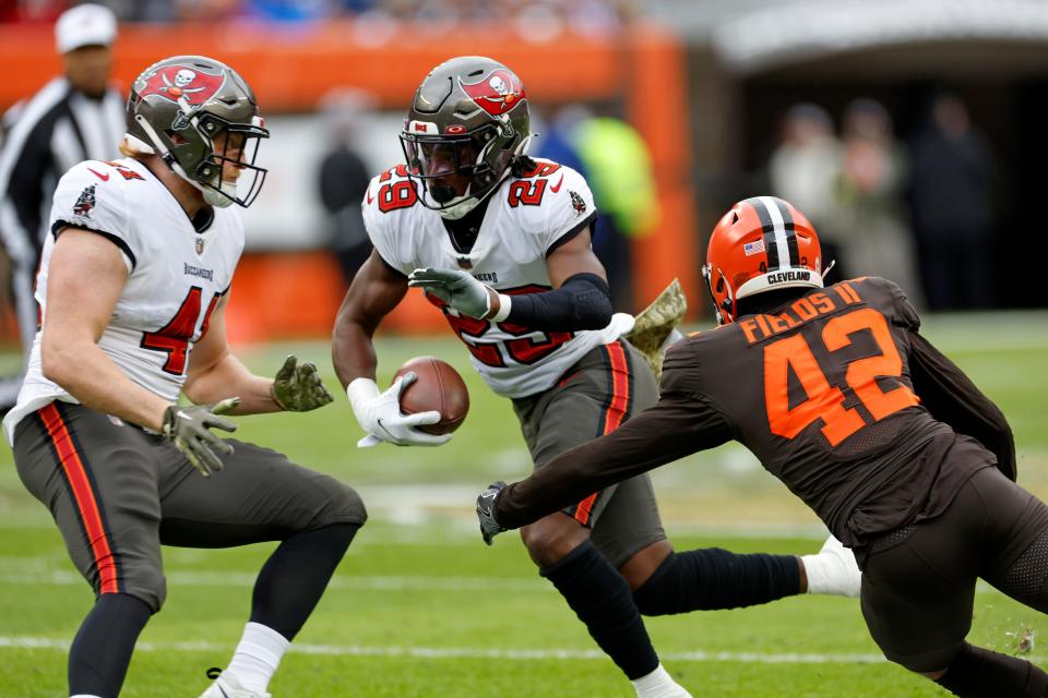 Tampa Bay Buccaneers cornerback Quandre Mosely (28) returns a punt during the first half of an NFL football game with Cleveland Browns linebacker Tony Fields II (42) defending in Cleveland, Sunday, Nov. 27, 2022. (AP Photo/Ron Schwane)