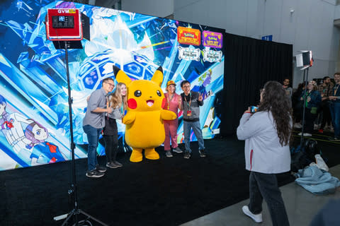 In this photo provided by Nintendo of America, a group takes a photo with Pikachu at PAX East