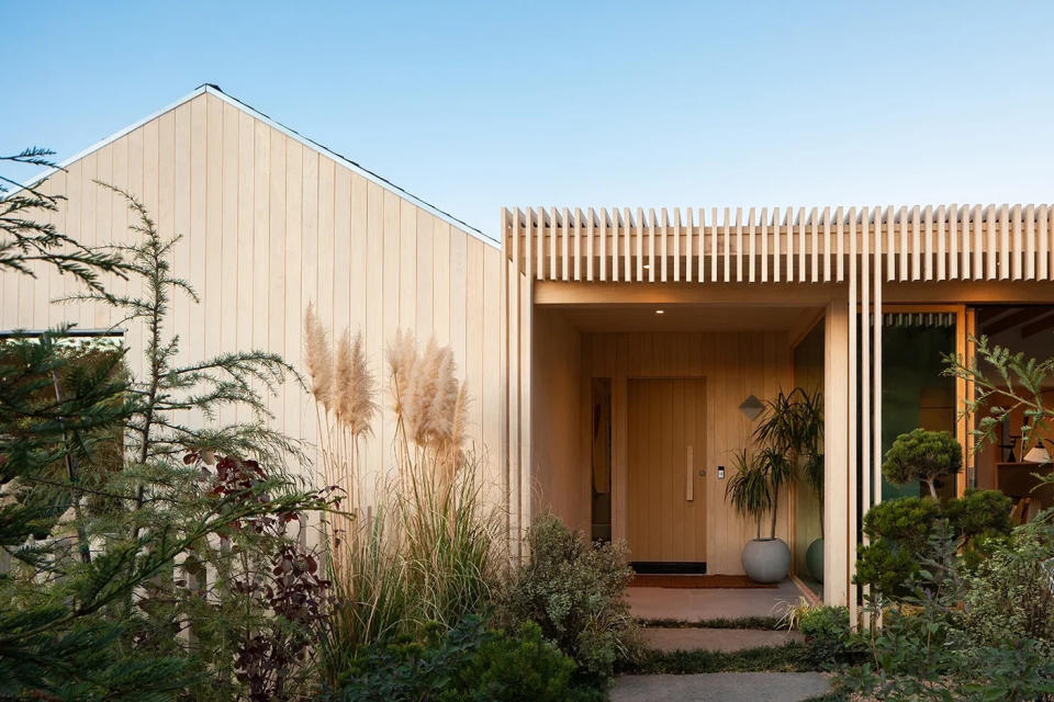 House with wood exterior and wood slat pattern along front.