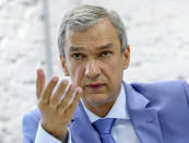 In this photo taken on Tuesday, Aug. 18, 2020, Pavel Latushko, former culture minister and Belarusian Ambassador to France, speaks during a news conference in Minsk, Belarus. A former culture minister and ambassador to France, is the only former senior official in an opposition council created to facilitate the transition of power amid massive protests challenging the extension of the 26-year rule of Belarus' authoritarian leader. (AP Photo/Sergei Grits)