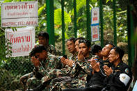 Soldiers attend the funeral a former Thai navy diver, Samarn Kunan, who died during the rescue mission for the 12 boys of the "Wild Boars" soccer team and their coach, near the Tham Luang cave complex, in the northern province of Chiang Rai, Thailand July 16, 2018. REUTERS/Tyrone Siu