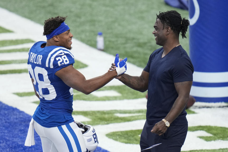 Indianapolis Colts' Jonathan Taylor (28) talks with former Indianapolis Colts running back Edgerrin James before an NFL football game between the Indianapolis Colts and the Los Angeles Rams, Sunday, Sept. 19, 2021, in Indianapolis. (AP Photo/AJ Mast)