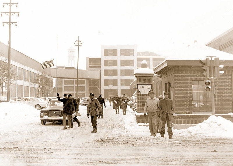 Studebaker Corp. workers emerge through Gate 1 on Sample Street on Dec. 9, 1963, the day the company announced the factory would close. Tribune Archives Photo