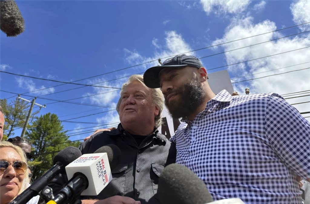 Republican Senate candidate Royce White, right, stands in solidarity with longtime Donald Trump ally Steve Bannon, as Bannon reports to the federal prison in Danbury, Conn., July 1, 2024. (AP Photo/Susan Haigh)<span class="credit"> – </span>