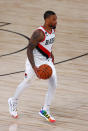 Portland Trail Blazers' Damian Lillard moves the ball downcourt against the Boston Celtics during an NBA basketball game Sunday, Aug. 2, 2020, in Lake Buena Vista, Fla. (Mike Ehrmann/Pool Photo via AP)