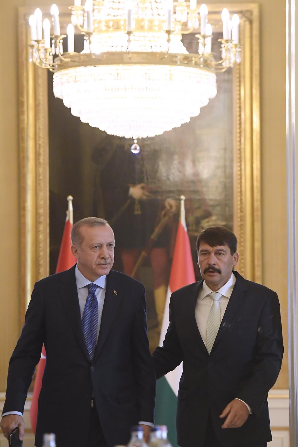 Turkish President Recep Tayyip Erdogan, left, and Hungarian President Janos Ader walk during their meeting in the presidential Alexander Palace in Budapest, Hungary, Monday, Oct. 8, 2018. Erdogan is paying a two-day official visit to Hungary. (Tamas Kovacs/MTI via AP)