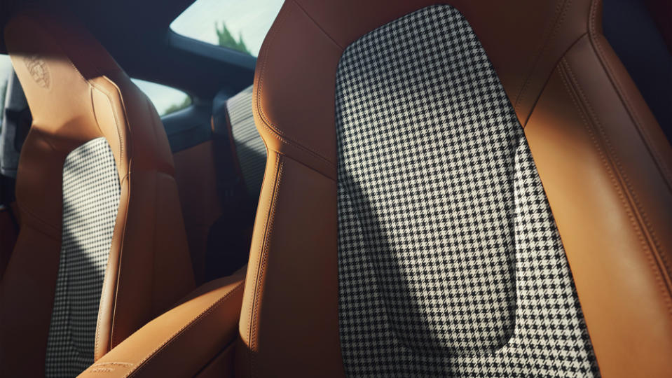 Seat centers and door panels are upholstered in the marque’s Pepita cloth. - Credit: Porsche AG.