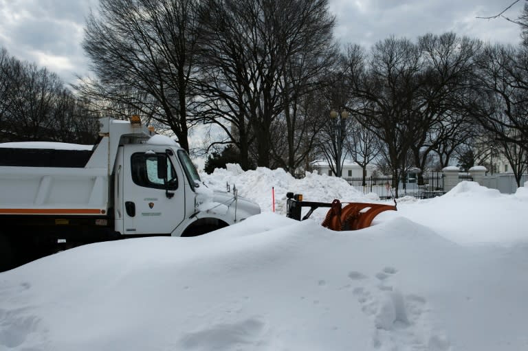 A US Park Service plow is seen parked in a snow bank on Pennsylvania Avenue as Washington, DC cleans up after a weekend blizzard on January 26, 2016