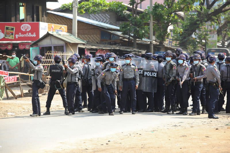 Riot police stand in the middle of a street during a protest against the military coup, in Naypyitaw