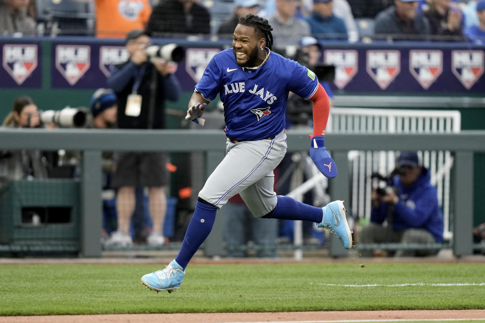 Toronto Blue Jays' Vladimir Guerrero Jr. runs home to score on a three-run triple hit by Bo Bichette during the third inning of a baseball game against the Kansas City Royals Monday, April 22, 2024, in Kansas City, Mo. (AP Photo/Charlie Riedel)