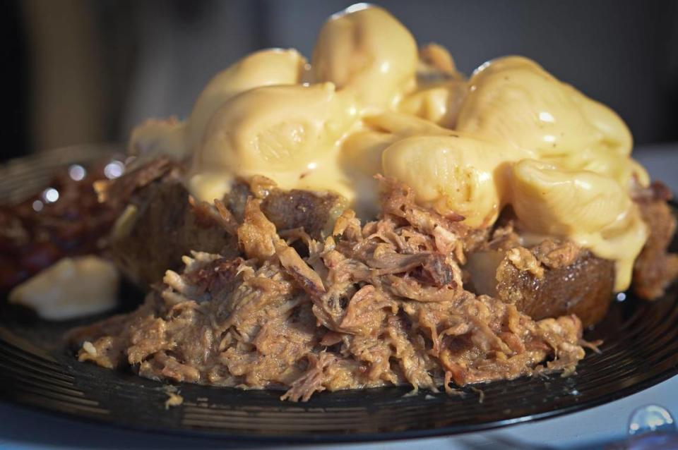 A baked potato loaded with pulled pork and topped with mac and cheese is one of the most popular items at Wardell Hooks’ Off the Hook BBQ in Parkville.