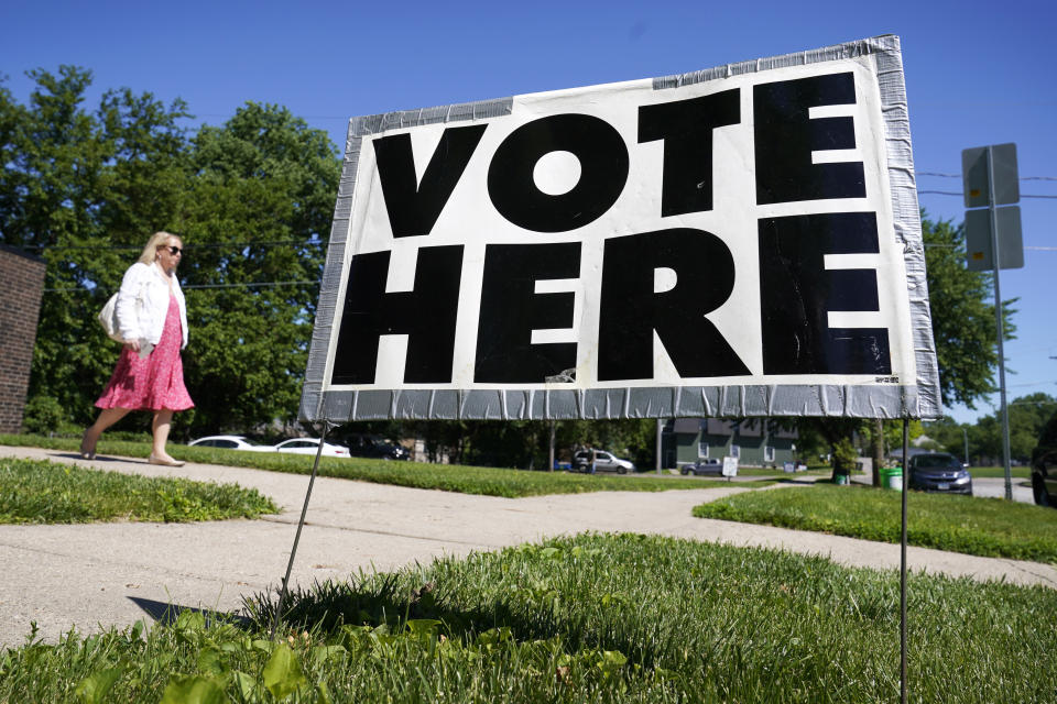 A voter leaves the Calvery Chapel after casting her ballot for the Iowa primary, Tuesday, June 7, 2022, in Des Moines, Iowa. (AP Photo/Charlie Neibergall)