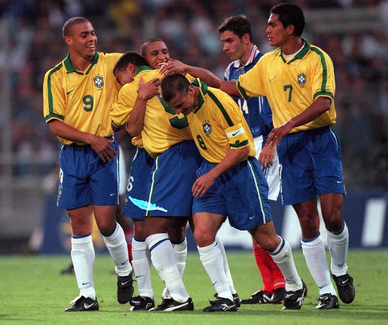 FILE PHOTO: Brazil defender Roberto Carlos celebrates with team mates after scoring with a stunning free kick in a 1-1 draw against the hosts in the Tournoi de France in Lyon.