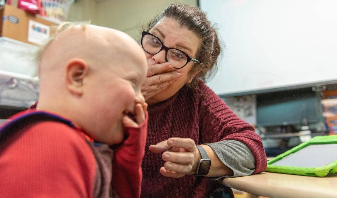 Alexa Scarlett, a special education teacher in the Shawnee Mission school district, jokes with first grader Crosby Orlando at their Overland Park school.