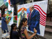 FILE - In this Feb. 21, 2020, file photo, children from an art school make paintings of U.S. President Donald Trump and India Prime Minister Narendra Modi ahead of Trump's India visit, in Mumbai, India. Trump is scheduled to visit India Feb. 24-25. President Donald Trump is ready for a king's welcome as he head to India on Sunday for a jam packed two-day tour. The visit will feature a rally at one of the world's largest stadiums, a crowd of millions cheering him on and a lovefest with a like-minded leader during an election year. (AP Photo/Rajanish Kakade, File)