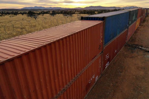 PHOTO: An aerial image shows a border wall constructed of shipping containers and topped with concertina wire along the US-Mexico border in the Coronado National Forest near Hereford, Arizona, Dec. 20, 2022. (Patrick T. Fallon/AFP via Getty Images)