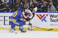 Columbus Blue Jackets' Cole Sillinger (34) passes the puck against St. Louis Blues' Ryan O'Reilly (90) during the first period of an NHL hockey game Saturday, Nov. 27, 2021, in St. Louis. (AP Photo/Michael Thomas)