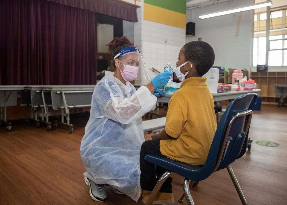 Medical assistant Rena Young administers a coronavirus test to a student at the Libertas School of Memphis, Tennessee, on March 18.