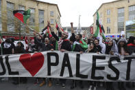 People hold placards and Palestinian flags as they march in solidarity with the Palestinian people amid the ongoing conflict with Israel, during a demonstration in Bristol, England, Saturday, May 15, 2021. (Andrew Matthews/PA via AP)