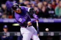 May 12, 2018; Denver, CO, USA; Colorado Rockies shortstop Trevor Story (27) hits a solo home run in the fifth inning against the Milwaukee Brewers at Coors Field. Mandatory Credit: Isaiah J. Downing-USA TODAY Sports