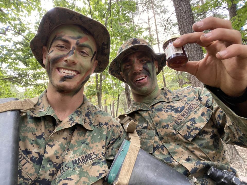 U.S. Marine 2nd Lt. Matthew Weiss of Tenafly, on right, and holding a container of honey, on a training mission at the Marine base in Quantico, Virginia, with 2nd Lt. Nicholas Scott, a Marine pilot. Besides Marine rations,  known as MREs, Weiss said the honey was the only "fresh food" he and Scott shared during a two-week training exercise in the forest.