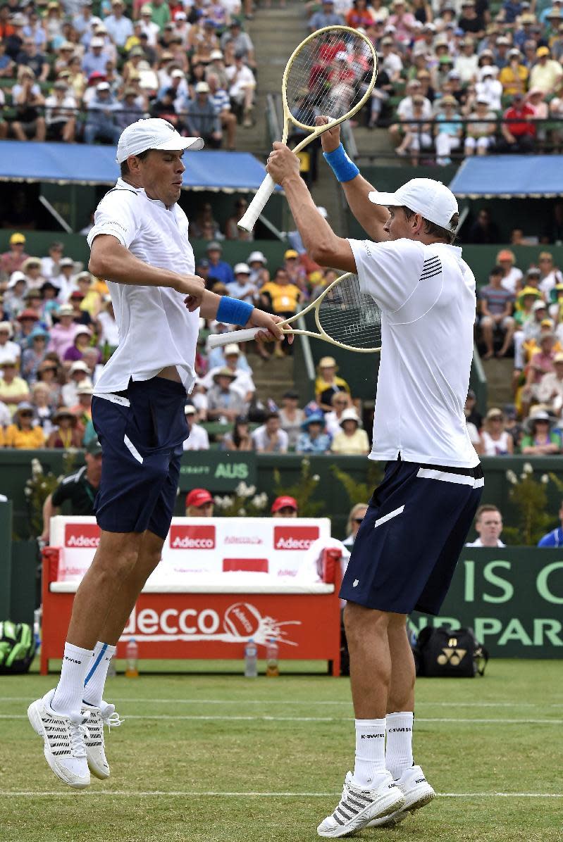 FILE- In this March, 2016 file photo, Bob Bryan, left, and his brother Mike of the United States celebrate after defeating Australia's Lleyton Hewitt and John Peers in their Davis Cup doubles match in Melbourne, Australia. Bob and Mike Bryan announced Sunday, January, 22, 2017, that they are retiring from playing Davis Cup for the United States after 14 years with the team. (AP Photo/Andrew Brownbill,File)