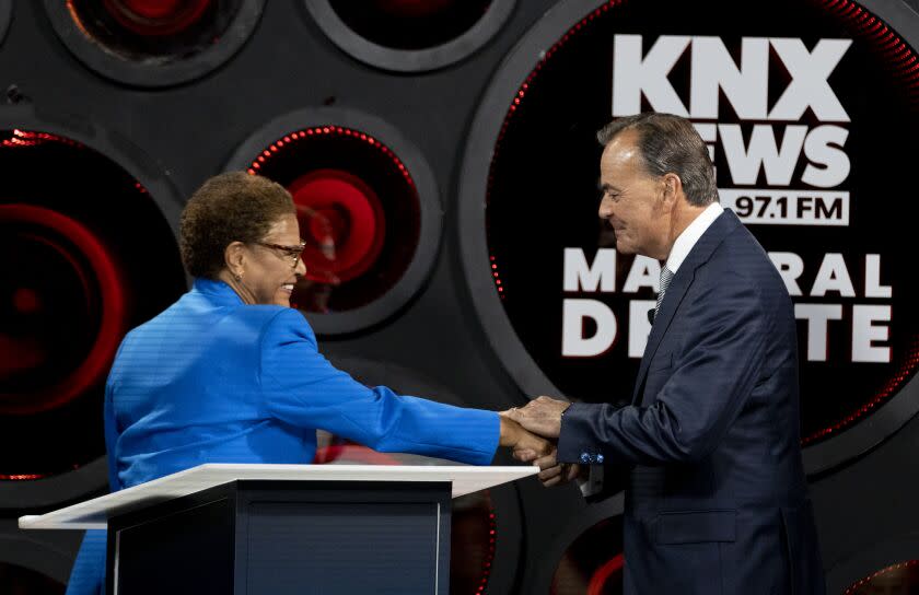 Los Angeles, CA - October 06: Los Angeles Mayoral candidates Congresswoman Karen Bass and builder Rick Caruso greet each other as they participate in the second one-on-one mayoral debate at the KNX Newsradio SoundSpace Stage in Los Angeles, Thursday, Oct. 6, 2022. (Allen J. Schaben / Los Angeles Times)