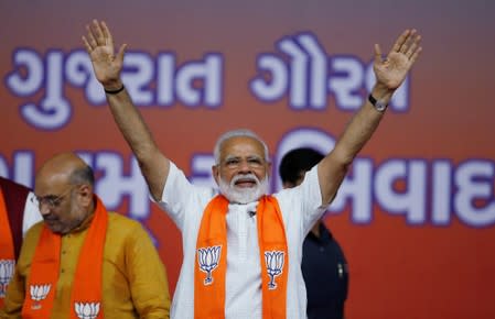 India's Prime Minister Narendra Modi gestures as he arrives to address his supporters at a public meeting in Ahmedabad