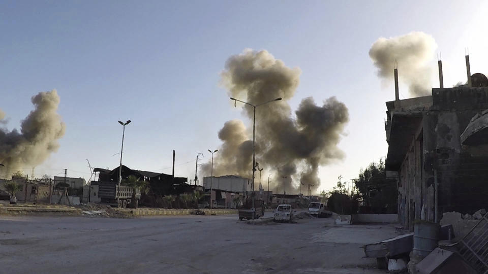 This photo released by the Syrian Civil Defense White Helmets, shows smoke rising after Syrian government airstrikes hit in the town of Douma, in eastern Ghouta (Syrian Civil Defense White Helmets via AP)