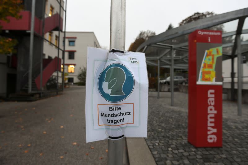 A sign reading "Please wear a face mask" is seen in front of the local high school prior to an ordered lock-down due to the further spreading of the coronavirus disease (COVID-19) in Pfarrkirchen