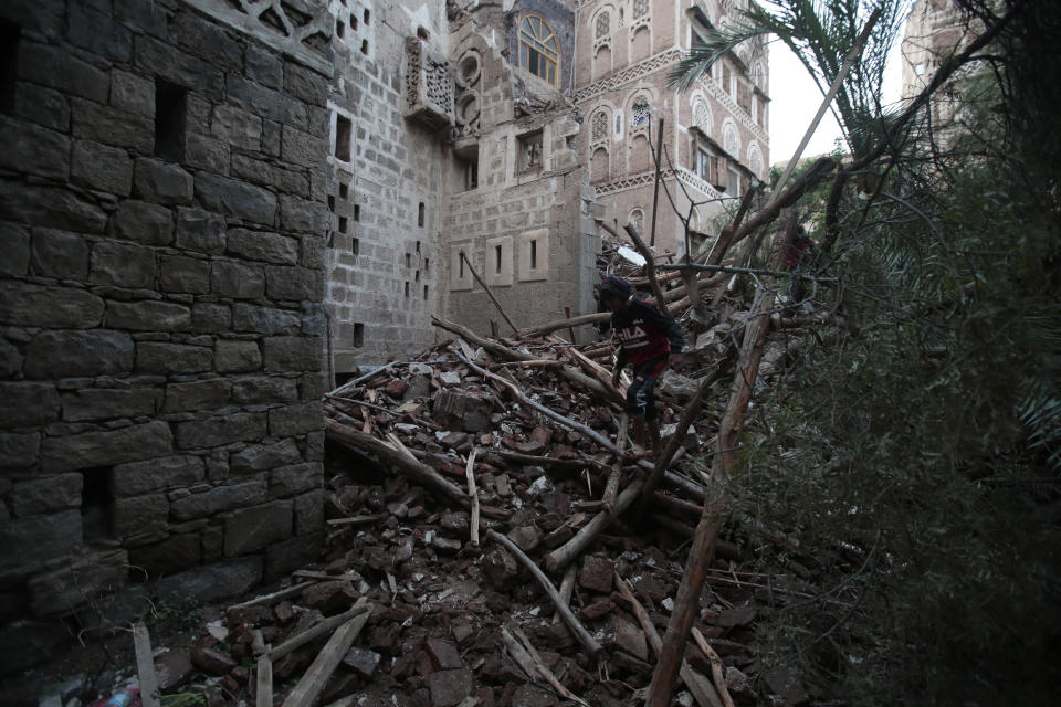 A person inspects a rains-collapsed UNESCO-listed building in the old city of Sanaa, Yemen, Wednesday, Aug 10, 2022. (AP Photo/Hani Mohammed)