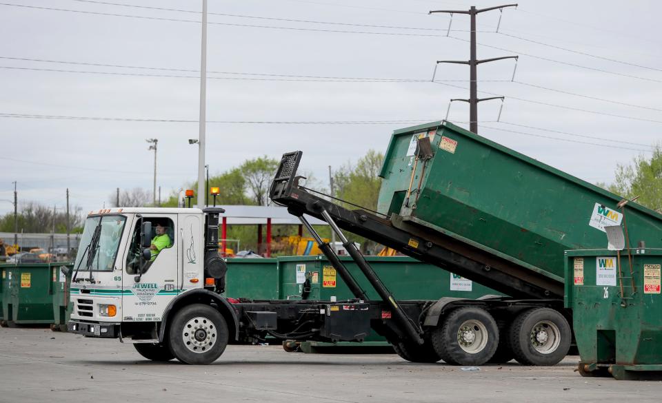 A Jewell Trucking and Grading employee loads a recycling container onto the truck Tuesday, May 4, 2021, at the Northside Drop Off Center Location at 6660 N. Industrial Road, Milwaukee.