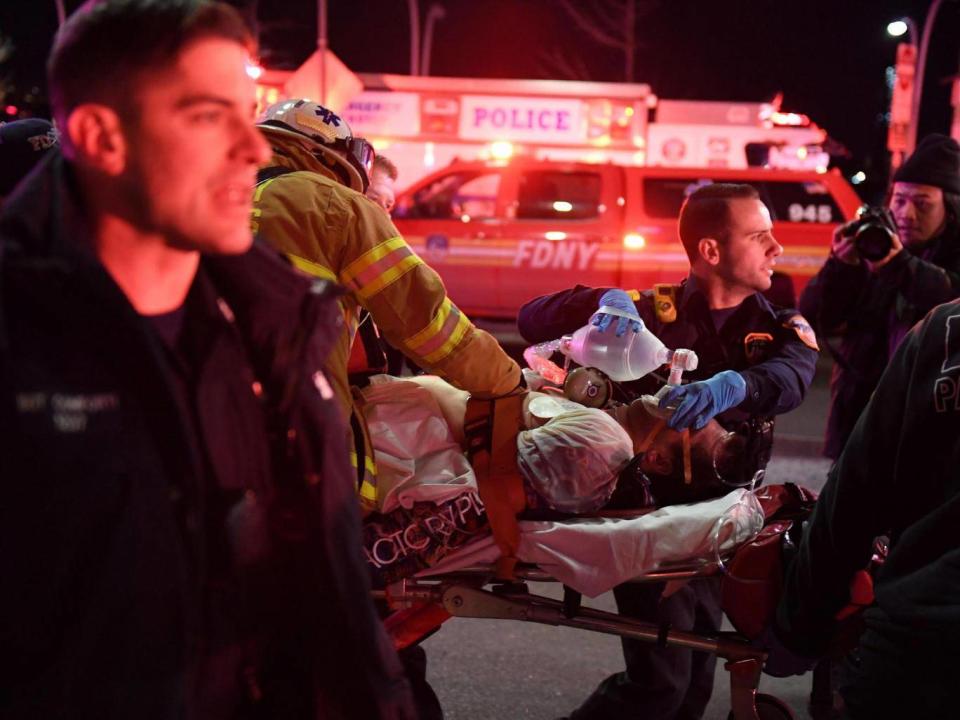 Paramedics and members of the NYFD perform CPR on a victim of the helicopter crash in New York. (REUTERS/Darren Ornitz)