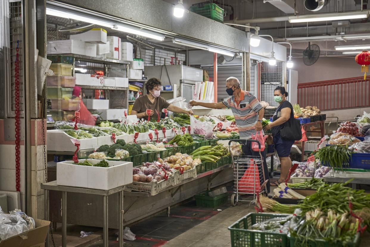 Shoppers buying vegetables at Chinatown Food Complex and Market in Singapore, on Thursday, Feb. 17, 2022. Photographer: Lauryn Ishak/Bloomberg