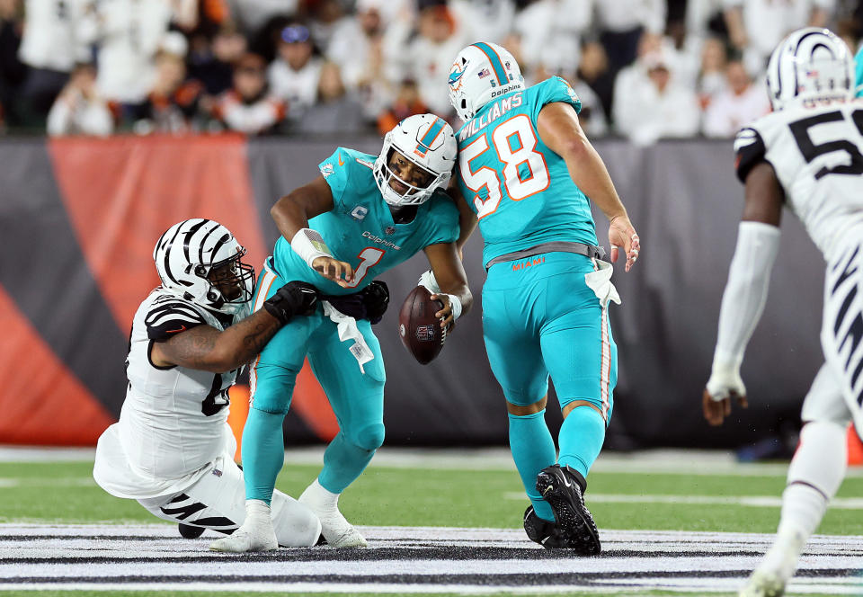 CINCINNATI, OHIO - SEPTEMBER 29:  Quarterback Tua Tagovailoa #1 of the Miami Dolphins is sacked by defensive tackle Josh Tupou #68 of the Cincinnati Bengals during the 2nd quarter of the game against the Cincinnati Bengals at Paycor Stadium on September 29, 2022 in Cincinnati, Ohio. (Photo by Andy Lyons/Getty Images)