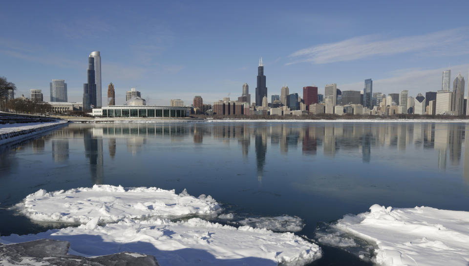 Ice floats on the surface of Lake Michigan Friday, Jan. 3, 2014, in Chicago. Single-digit temperatures are hitting Illinois after the state was blanketed in snow. Meanwhile, residents are bracing for a deep freeze. Highs early next week likely won't reach zero and wind chills could sink to 45 below. (AP Photo/M. Spencer Green)