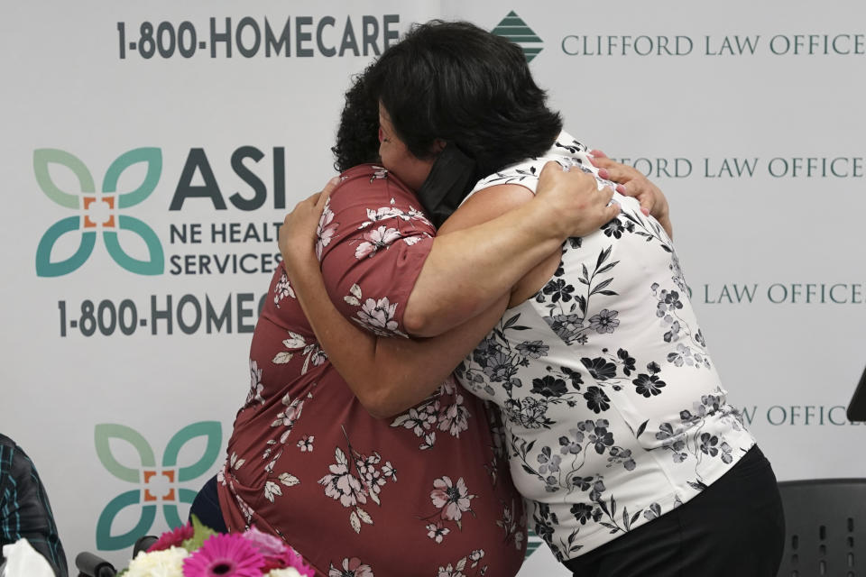 In this photo provided by Clifford Law Offices, Itza Pantoja, left, hugs Karina Aguilar at a news conference on Aug. 3, 2021, at the office of ASI/NE Healthcare Services in Chicago. After Itza Pantoja's severely disabled son died at the age of 16, she made it her mission to ensure that the wheelchairs, beds and other equipment and supplies that had helped him got to others who needed them. Many of the items, including a car seat, standing chair and bed, went to Felipe Aguilar, a 12-year-old Chicago boy with cerebral palsy. (Clifford Law Offices, Chicago via AP)