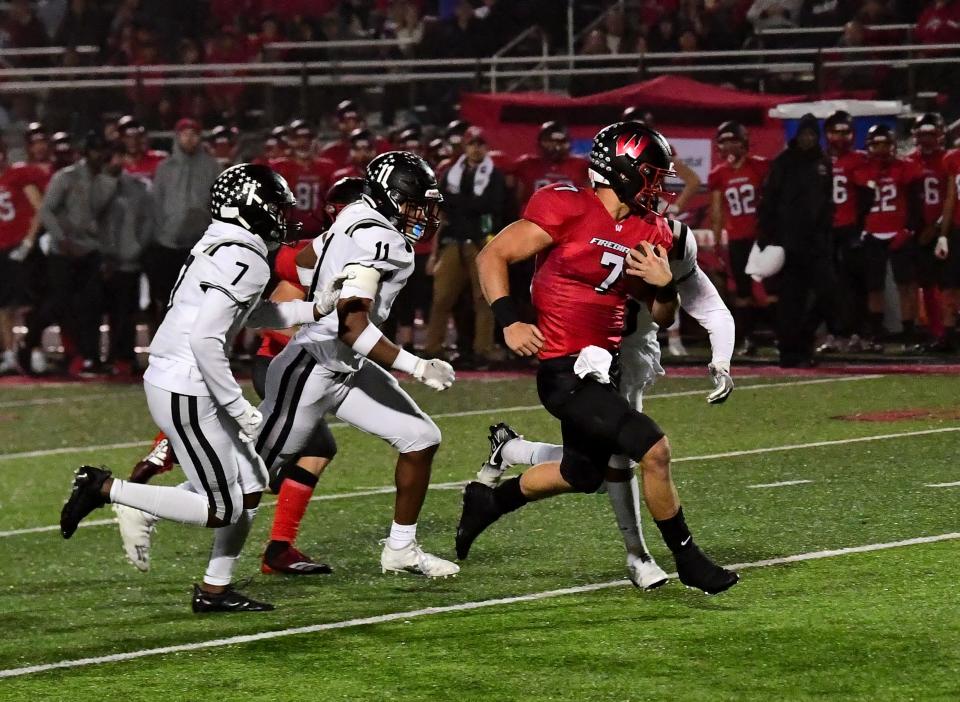 Lakota West quarterback Mitch Bolden (7) runs away from the Lakota East defense for a long gain, Oct. 22, 2021.