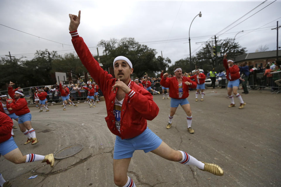 Members of the all-male dance group "The 610 Stompers" perform during the Krewe of Proteus Mardi Gras Parade in New Orleans, Monday, Feb. 16, 2015. 