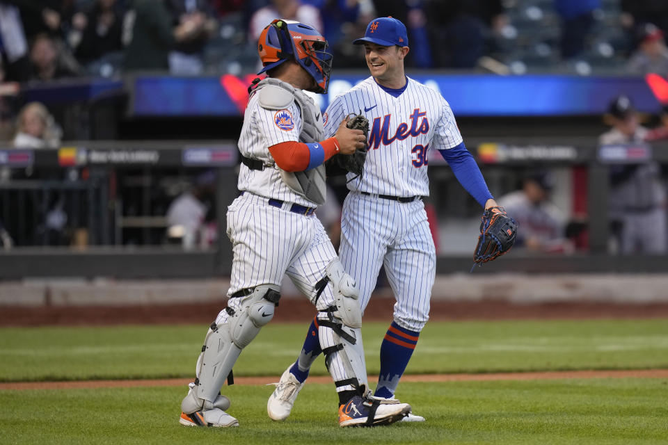 New York Mets relief pitcher David Robertson, right, celebrates with catcher Francisco Alvarez after Alvarez made the final out during the ninth inning of the second baseball game of a doubleheader against the Atlanta Braves at Citi Field, Monday, May 1, 2023, in New York (AP Photo/Seth Wenig)