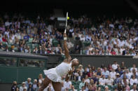 Coco Gauff of the US serves to Slovenia's Kaja Juvan during the women's singles third round match on day six of the Wimbledon Tennis Championships in London, Saturday July 3, 2021. (AP Photo/Alastair Grant)