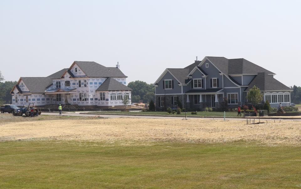 A home still under construction and a completed unit that is part of Orchard Ridge a 78-unit development by Toll Brothers straddling Mahwah and Upper Saddle River. Construction was shut down after two rain storms sent runoff into neighboring homes and driveways. 