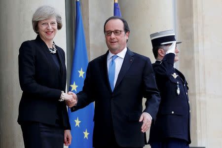 French President Francois Hollande (R) greets Britain's Prime Minister Theresa May at the Elysee Palace in Paris, France, July 21, 2016. REUTERS/Philippe Wojazer