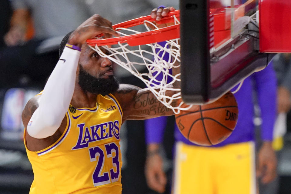 Los Angeles Lakers forward LeBron James dunks against the Miami Heat during the first half in Game 4 of basketball's NBA Finals Tuesday, Oct. 6, 2020, in Lake Buena Vista, Fla. (AP Photo/Mark J. Terrill)